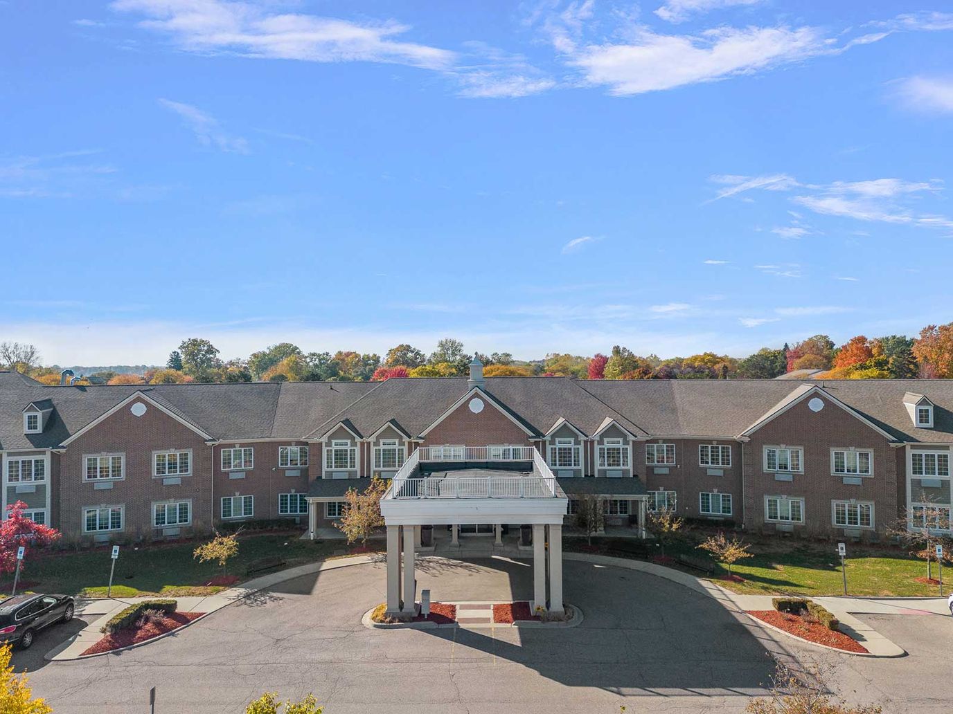 Maple Manor, nursing home in Escondido, CA — Main entrance of a senior living facility with landscaped surroundings