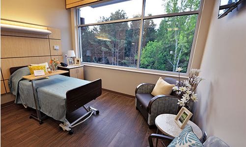Bright resident room with a bed and window view