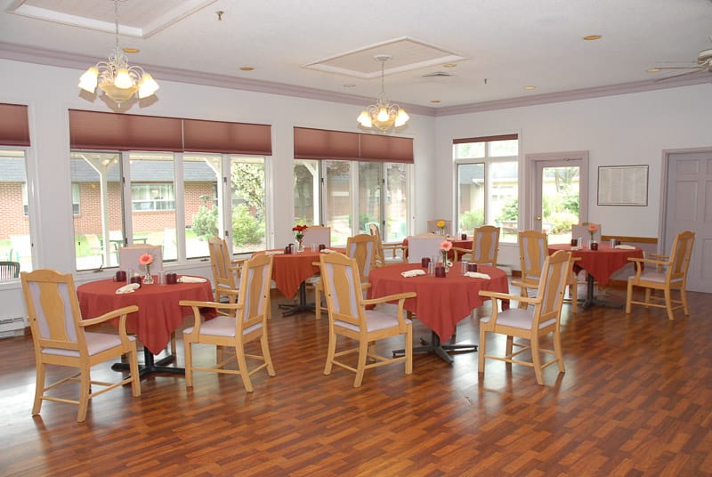 Bright dining room with tables set for meals
