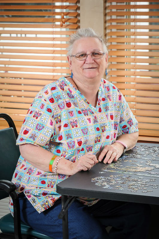 Resident working on a puzzle in a common area