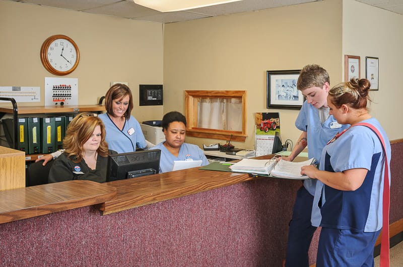 Staff assisting residents at the reception area