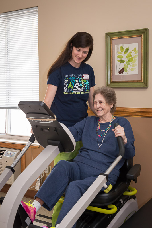 Resident engaging in occupational therapy with a staff member