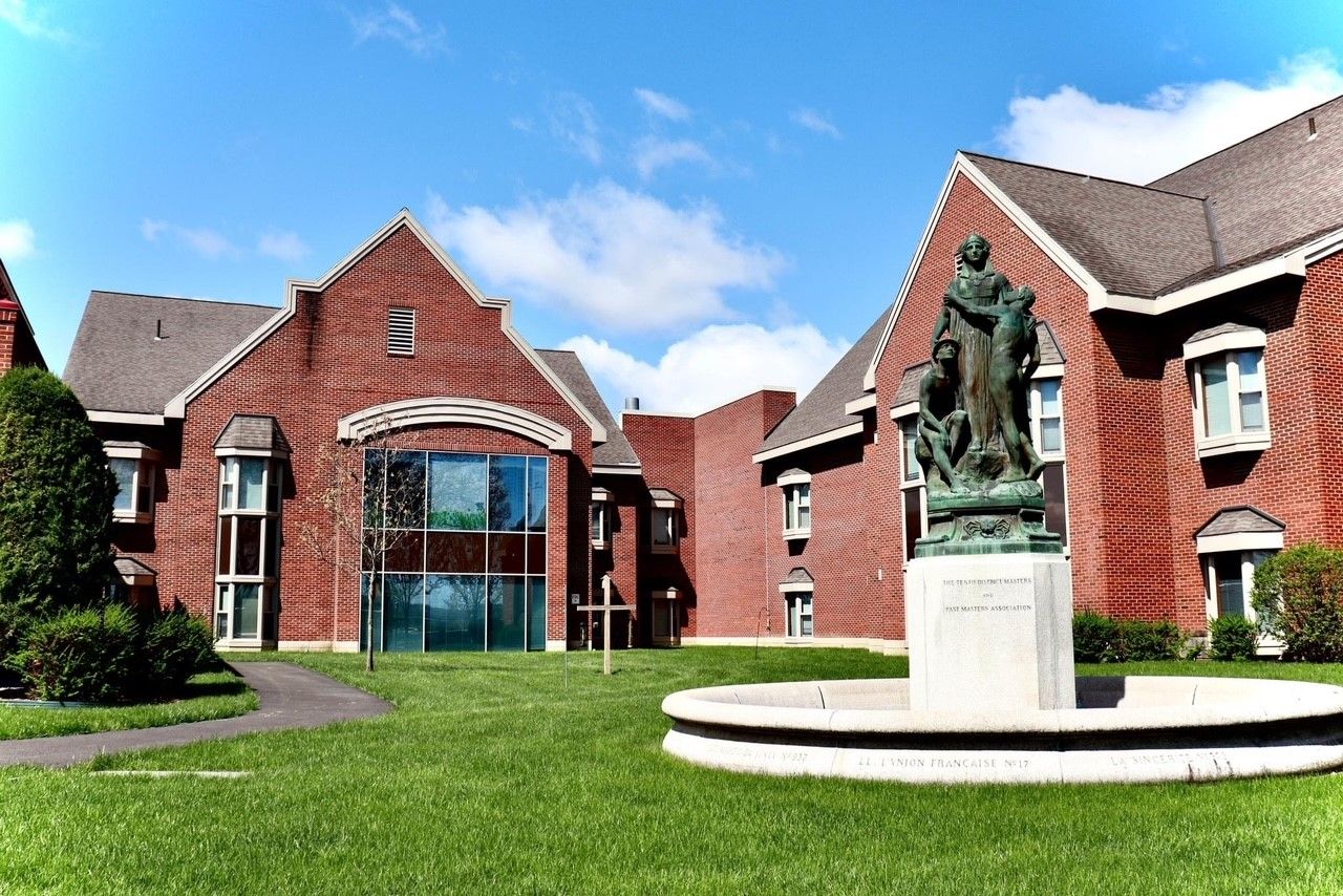 Exterior view of a senior living facility with gardens