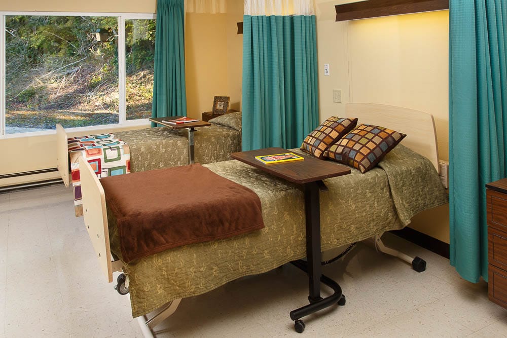 Resident room with two adjustable beds and decorations