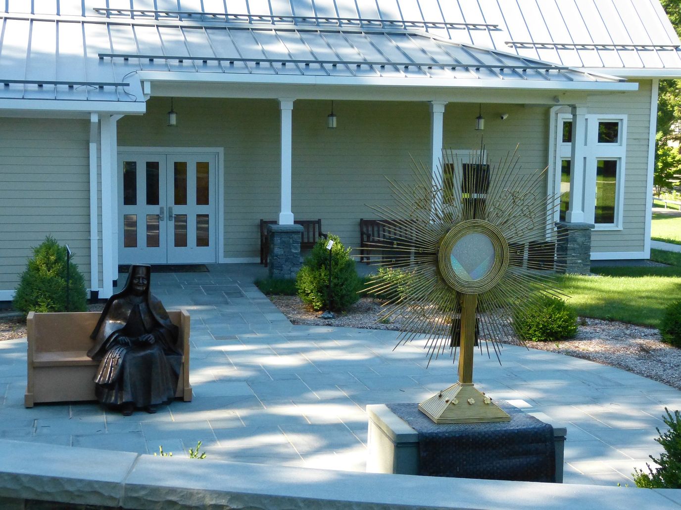 Outdoor space with a statue and seating area