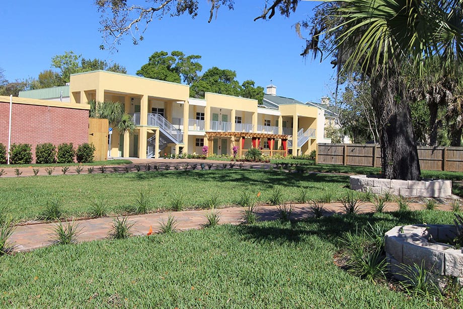 Exterior view of assisted living facility with green space