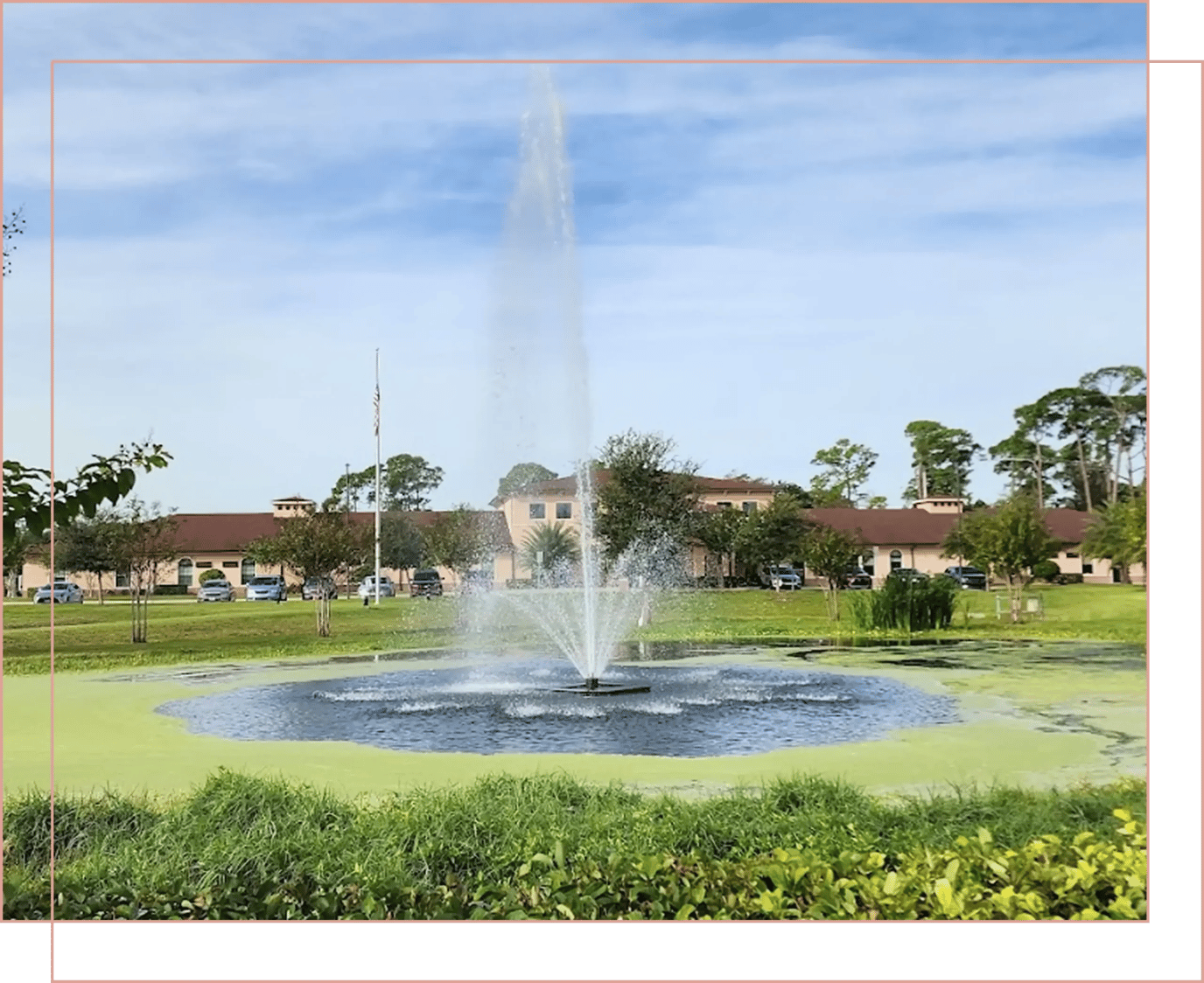 A scenic outdoor view of the facility's pond and fountain