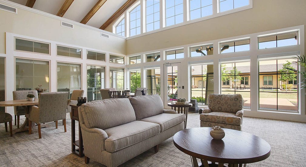 Bright common area with seating and large windows