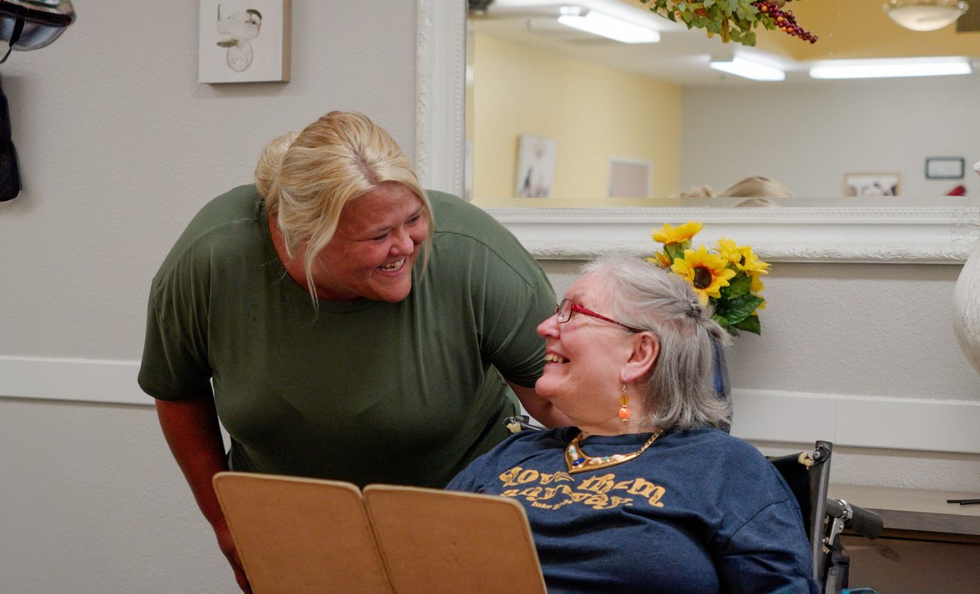 Staff member engaging with a resident in a care setting