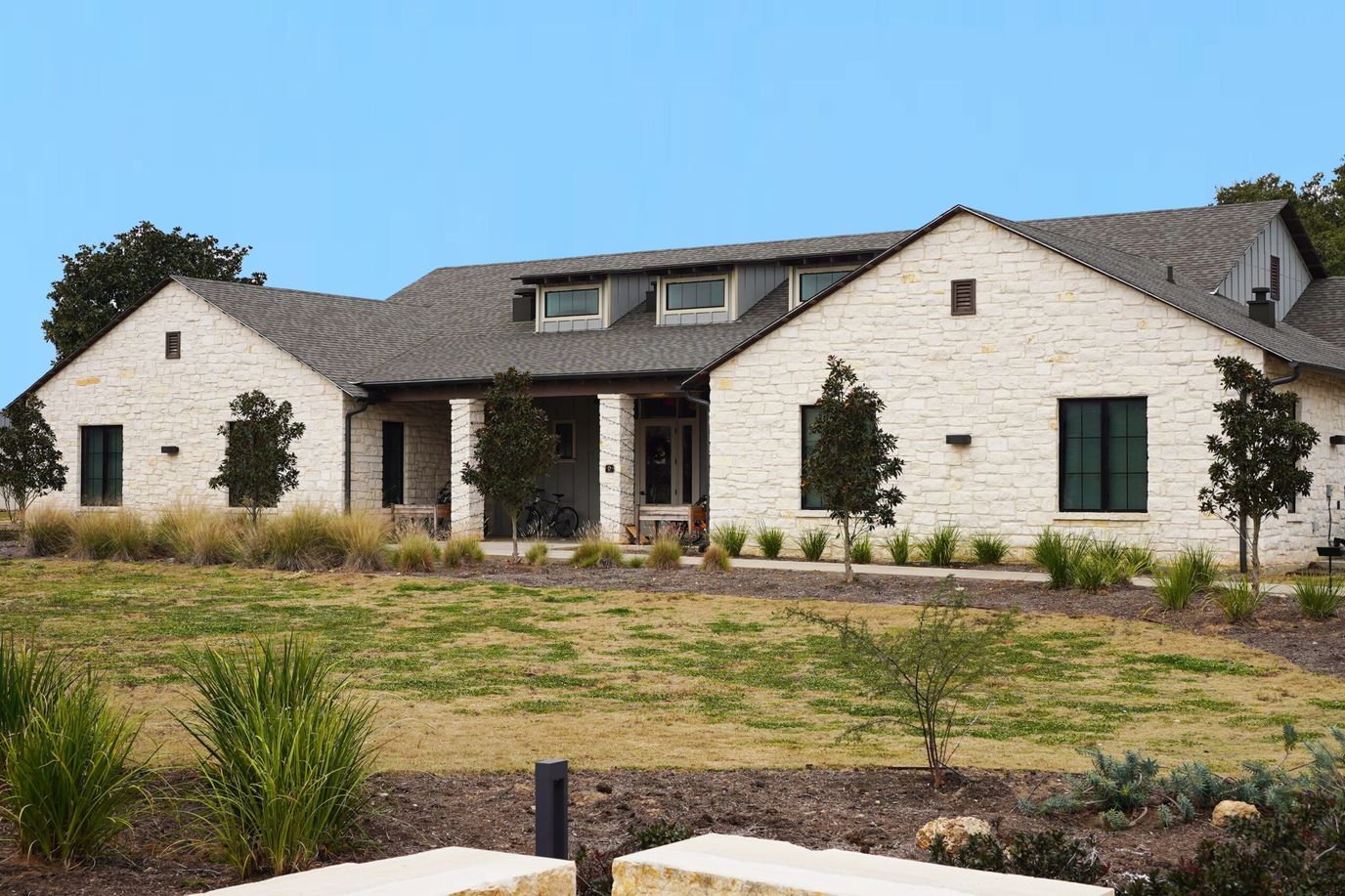 Exterior view of a senior living facility surrounded by landscaping