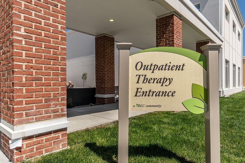 Signage for outpatient therapy entrance at facility.