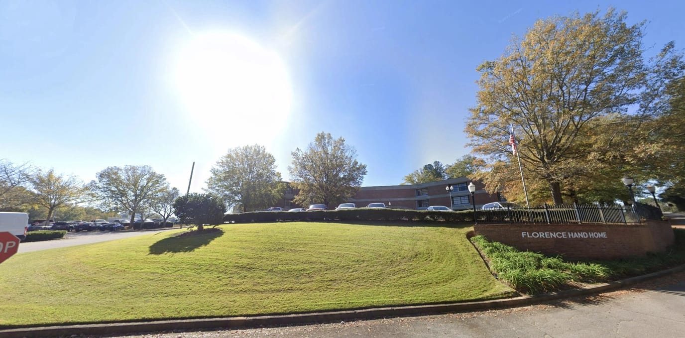 Building exterior of Florence Hand Home with landscaping and entrance