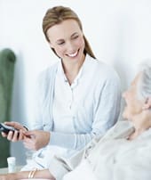 Twin Oaks Convalescent Center, Nursing Home in Alma, GA — Caregiver assisting elderly resident with a cheerful smile