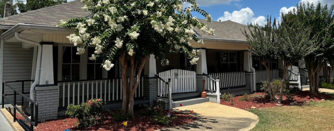 Exterior view of Azalea Manor with blooming flowers