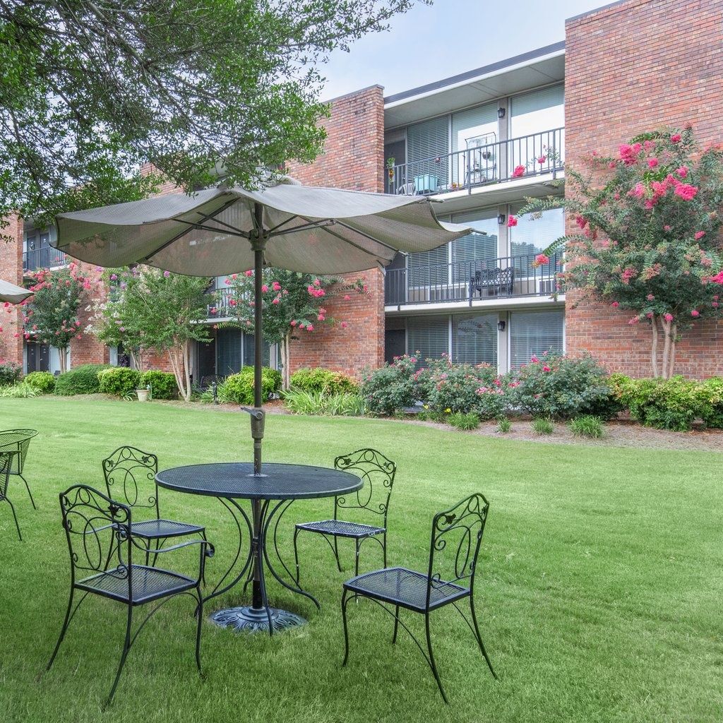 Outdoor seating area with tables and flowers