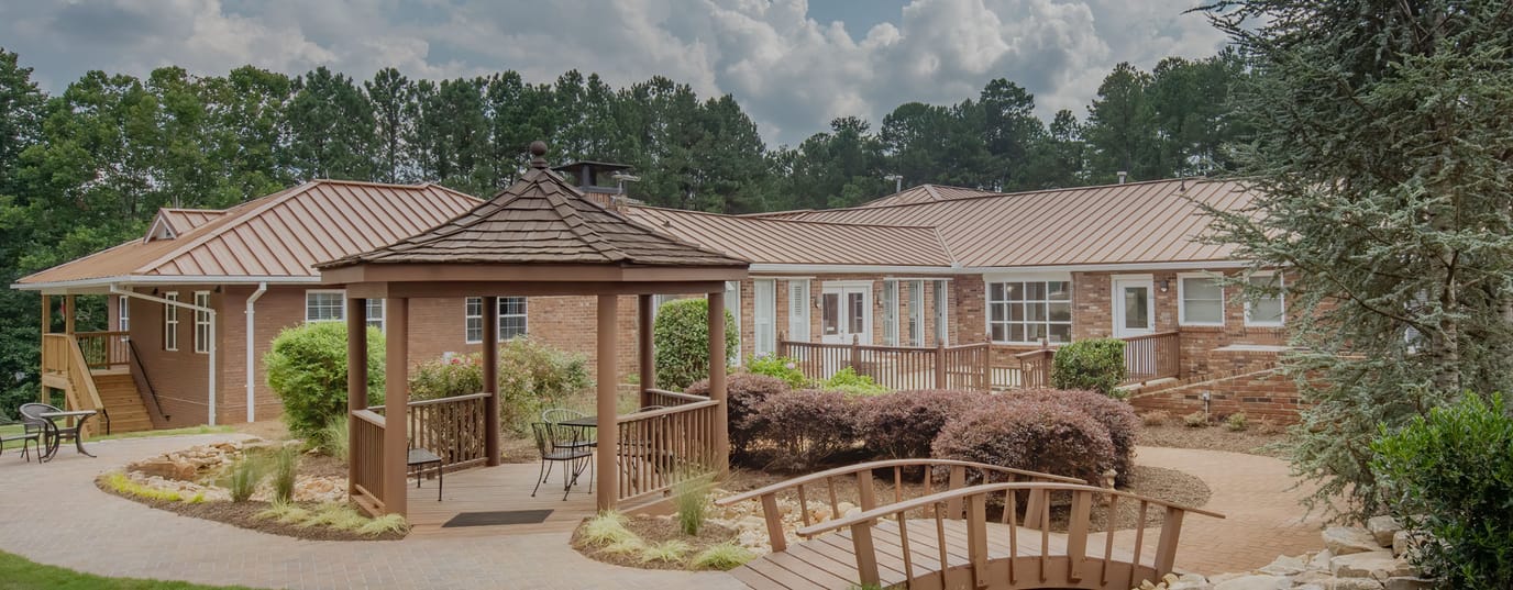 Exterior view of facility with gardens and seating areas