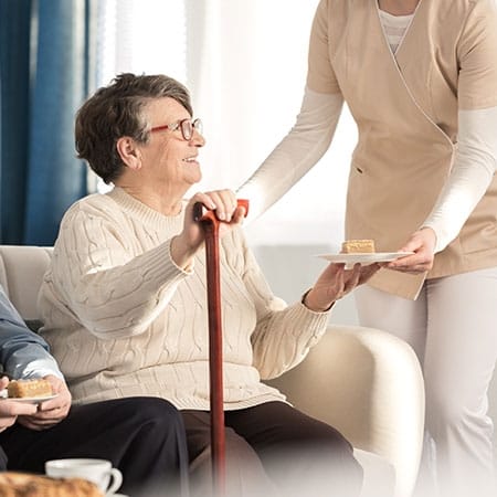 Mountainside of Warm Springs, assisted living in Warm Springs, GA — Senior resident receiving a dessert from staff member