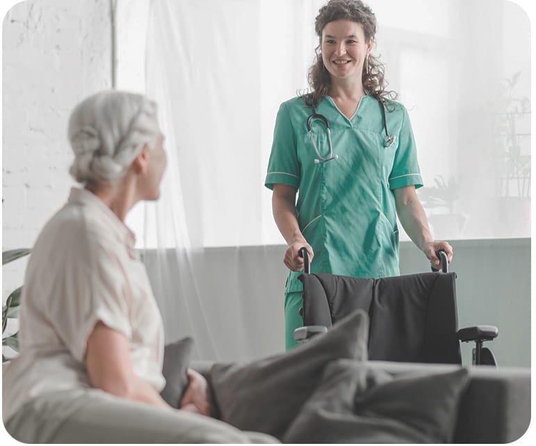 Regency House of Buford, assisted living in Buford, GA — Nurse assisting a resident with a wheelchair