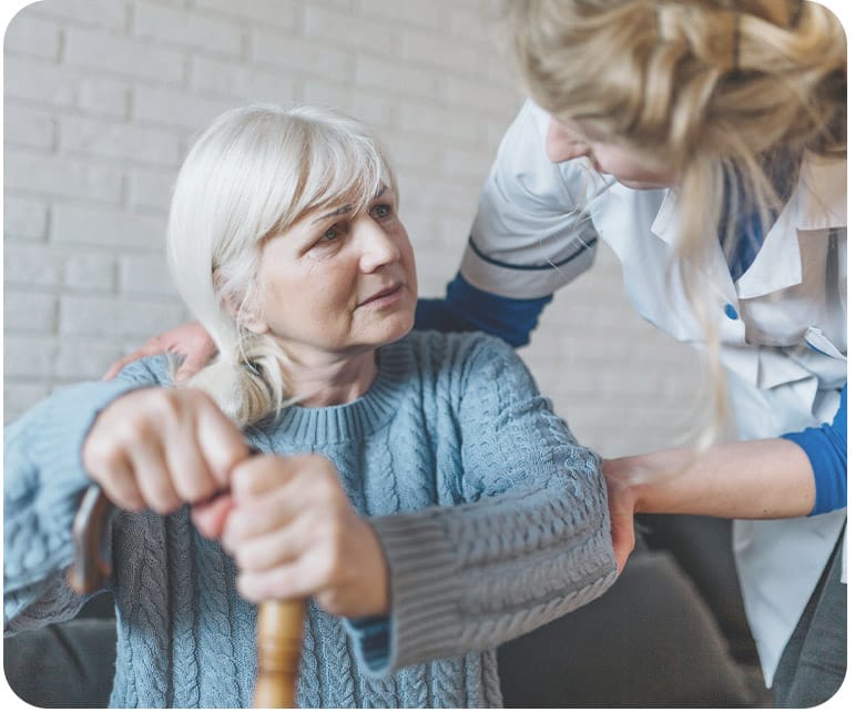 Regency House of Buford, assisted living in Buford, GA — Caregiver assisting a senior woman in a cozy setting