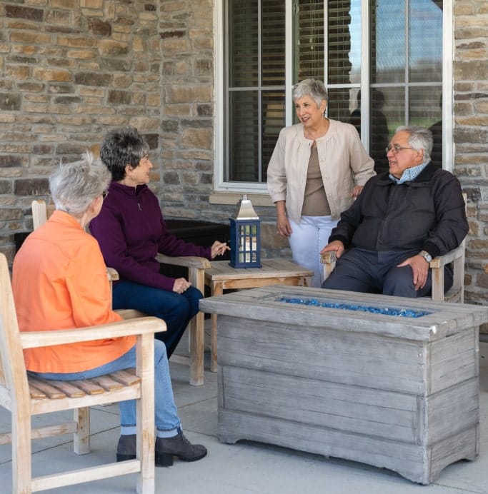 Residents enjoying conversation on an outdoor patio