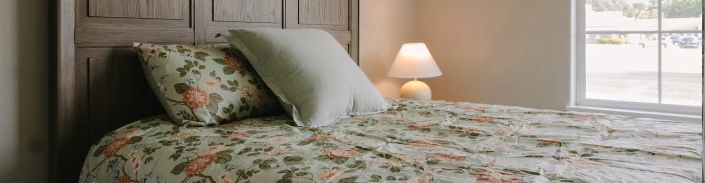 Cozy bedroom with floral bedding and warm lighting
