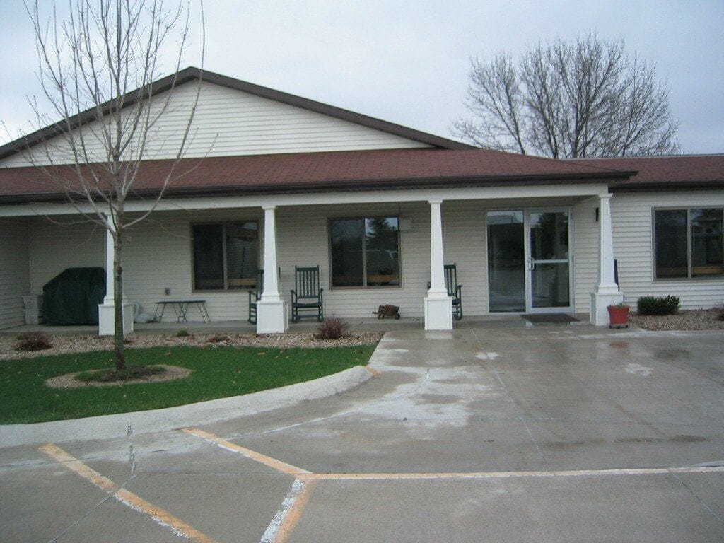Exterior view of Southcrest Manor II with seating area
