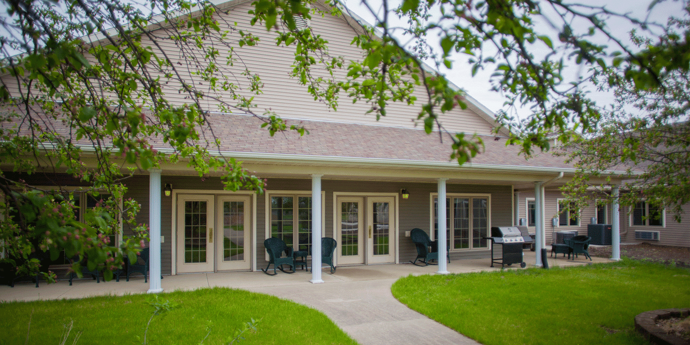 Exterior view of the assisted living facility with seating area