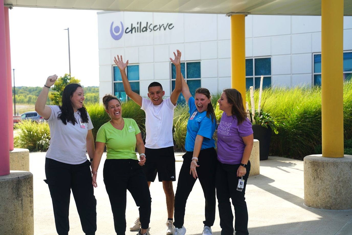 Staff and residents celebrating outside the Childserve facility