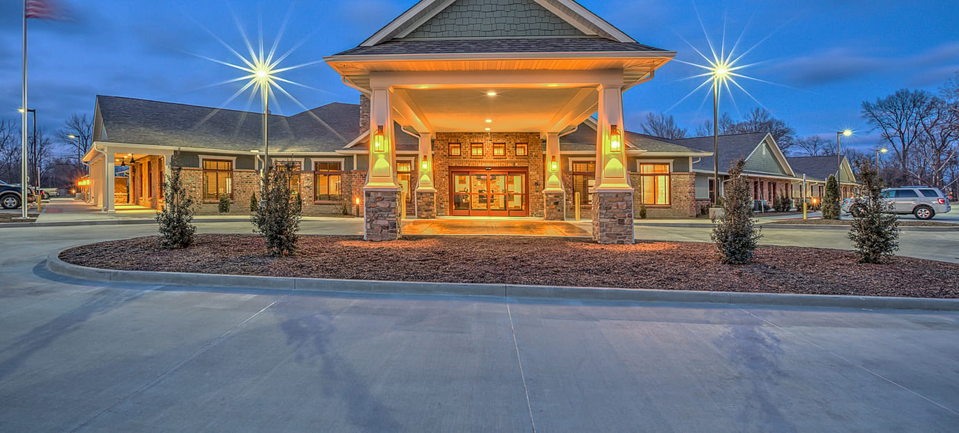 Exterior view of Stillwater Senior Living entrance during twilight