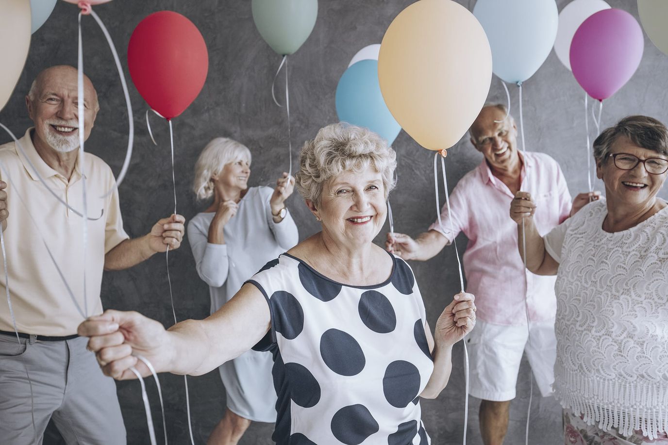 Seniors celebrating with balloons at a party