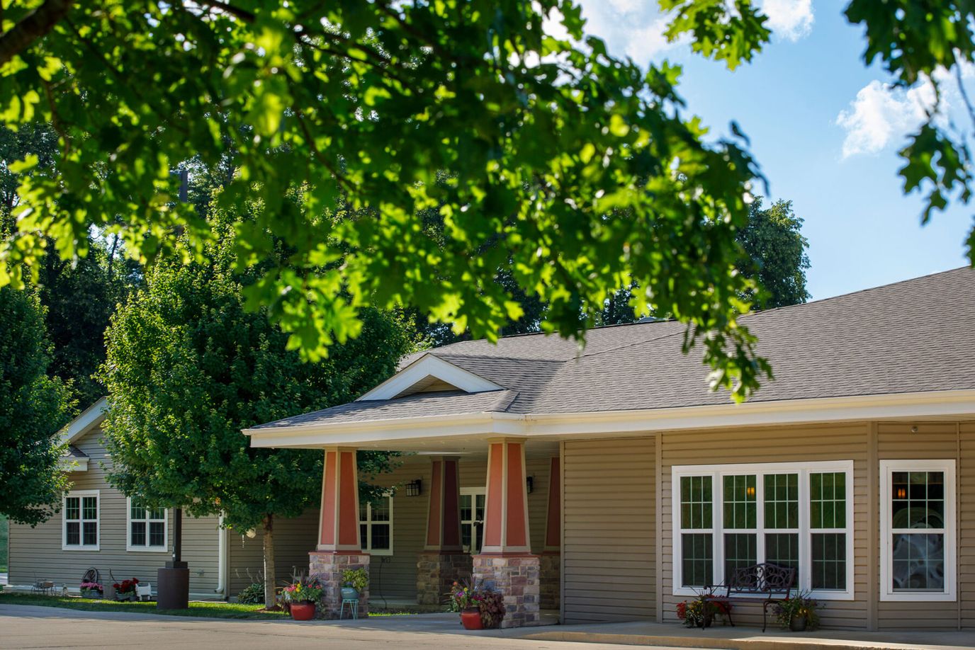 Exterior view of a senior living facility with trees