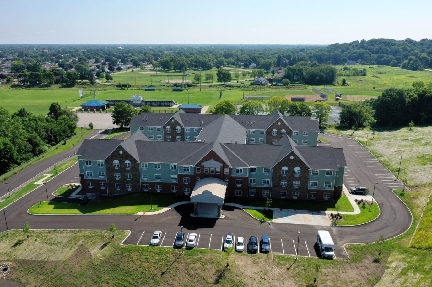 Aerial view of a senior living facility surrounded by greenery