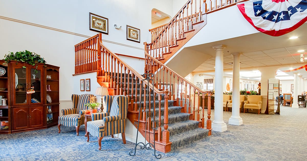 Bright interior lobby with staircase and comfortable seating