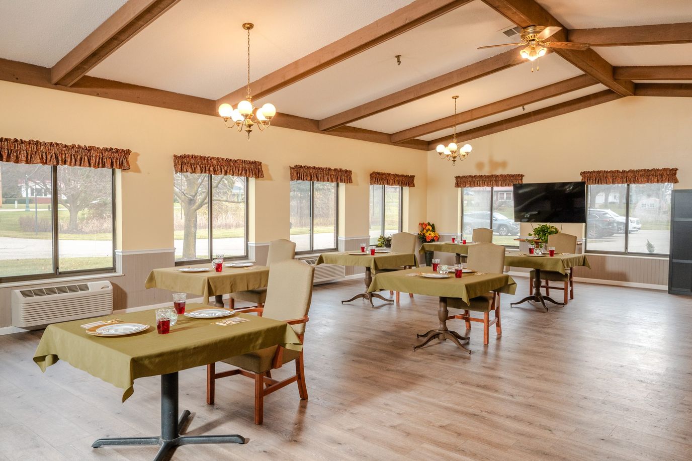 Bright dining room with tables set for residents