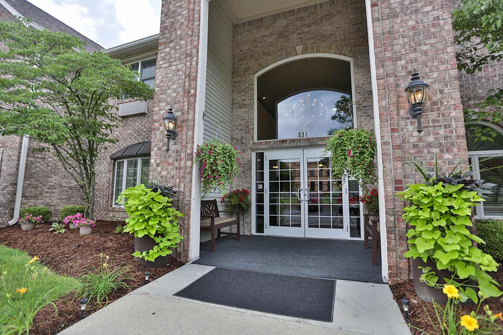 Main entrance of Crownpointe of Greenfield with flowers