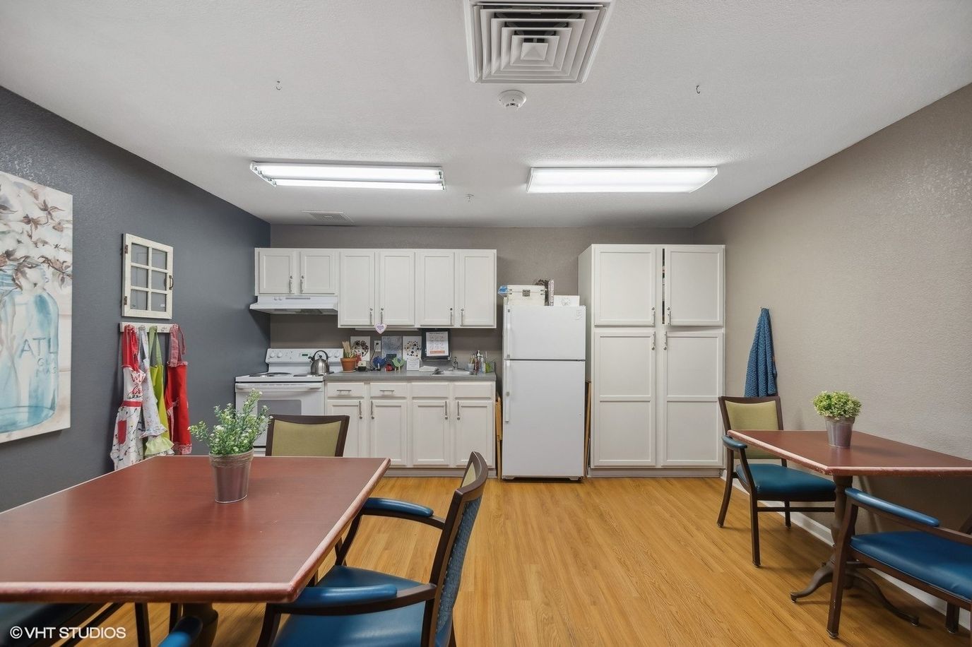 Bright kitchen area with tables and seating