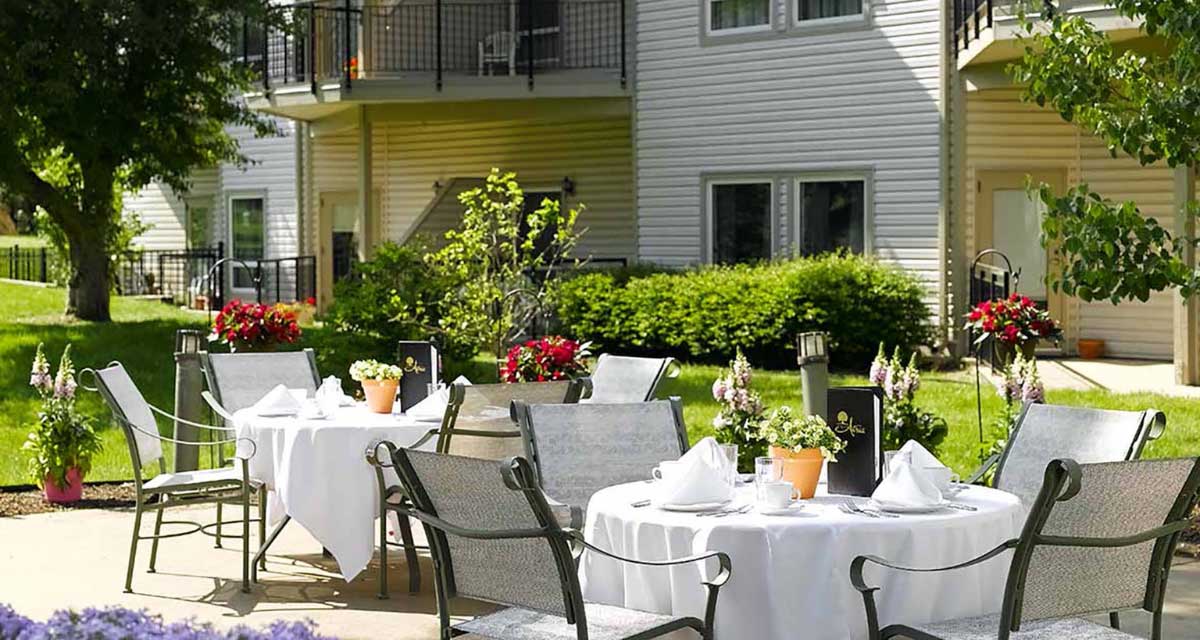 Outdoor dining space with tables and flowers