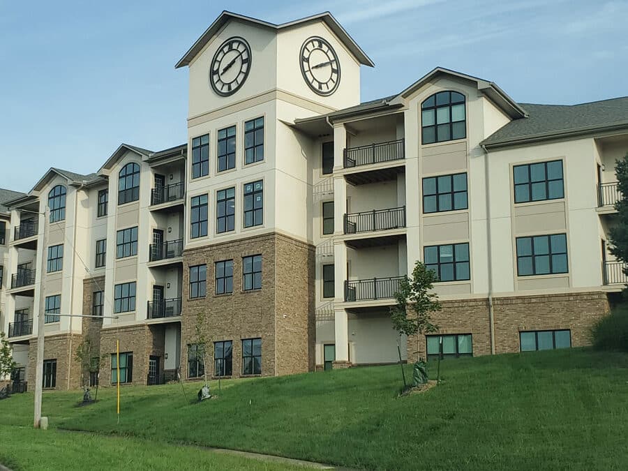 The exterior of a senior living facility with clock tower.