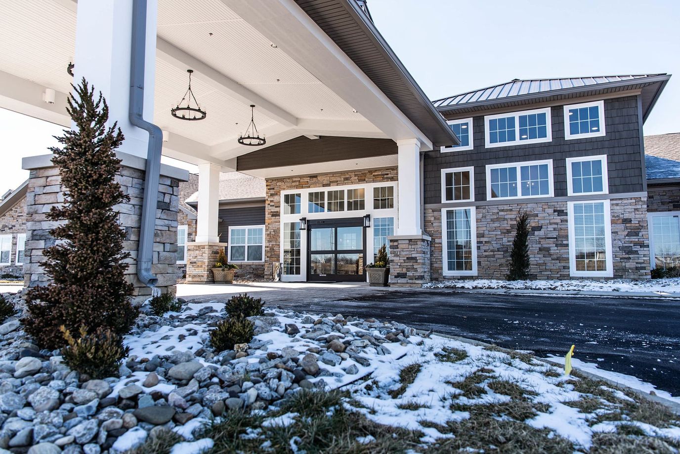 Front entrance of Charter Senior Living of Murray with snow