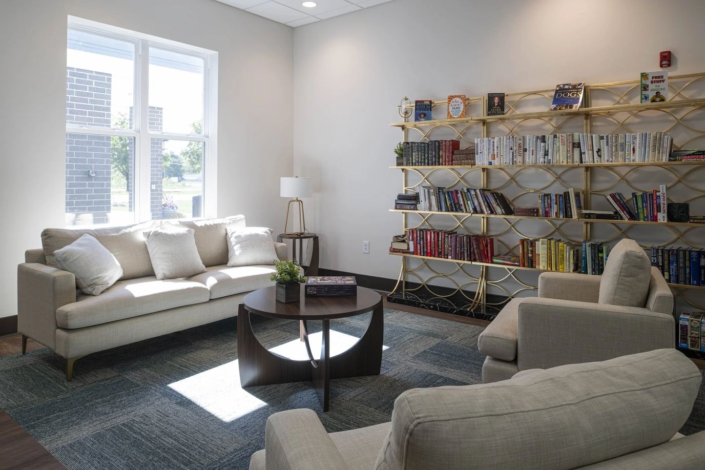 Cozy common area with seating and bookshelves