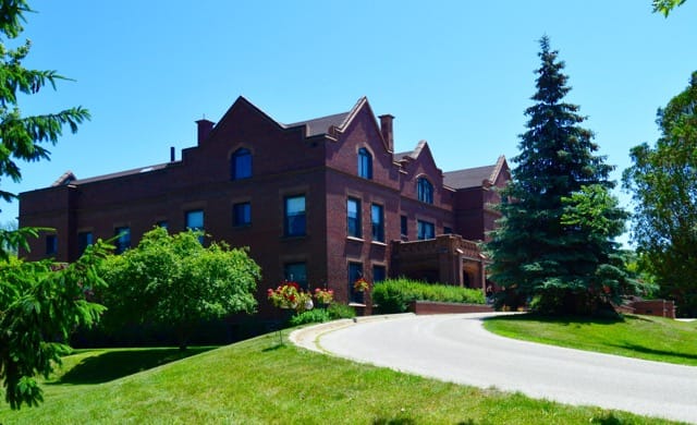 Exterior view of Hume Home of Muskegon surrounded by greenery