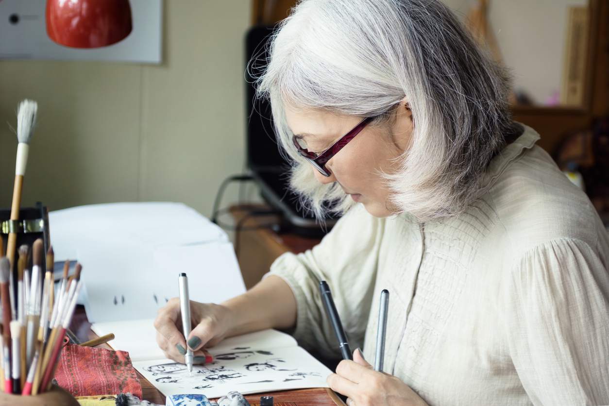 Resident engaged in an art activity with pens and paper