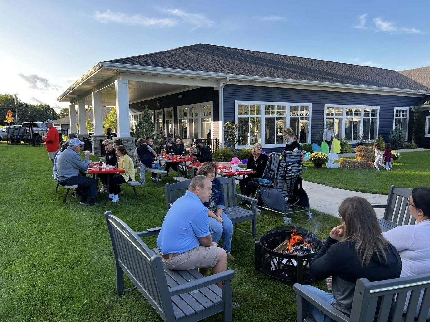 Residents enjoying an outdoor gathering by a fire pit