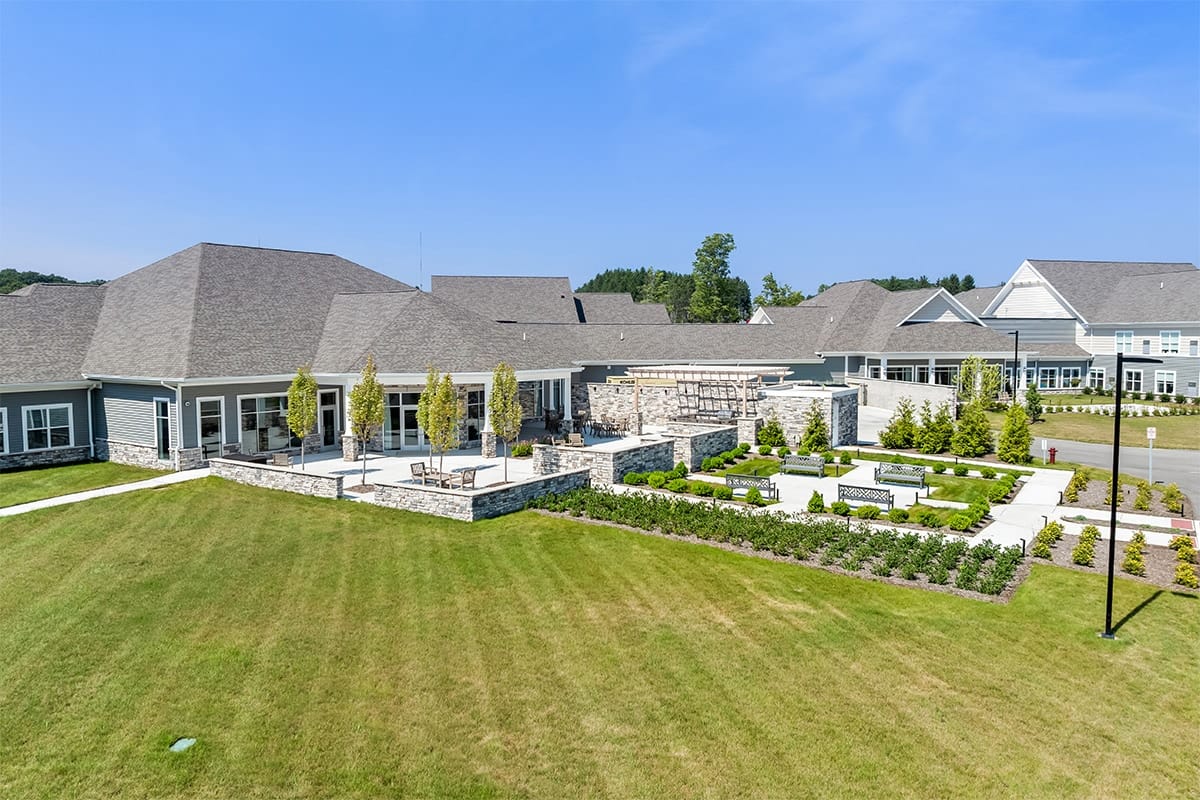 Aerial view of a senior living facility with landscaped gardens