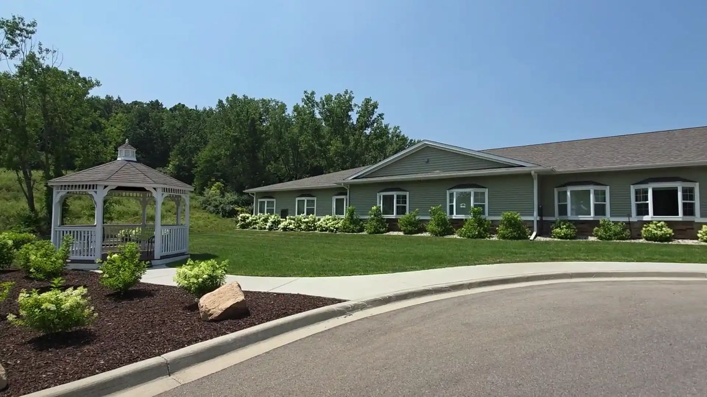 Exterior view of a senior living facility with landscaped garden