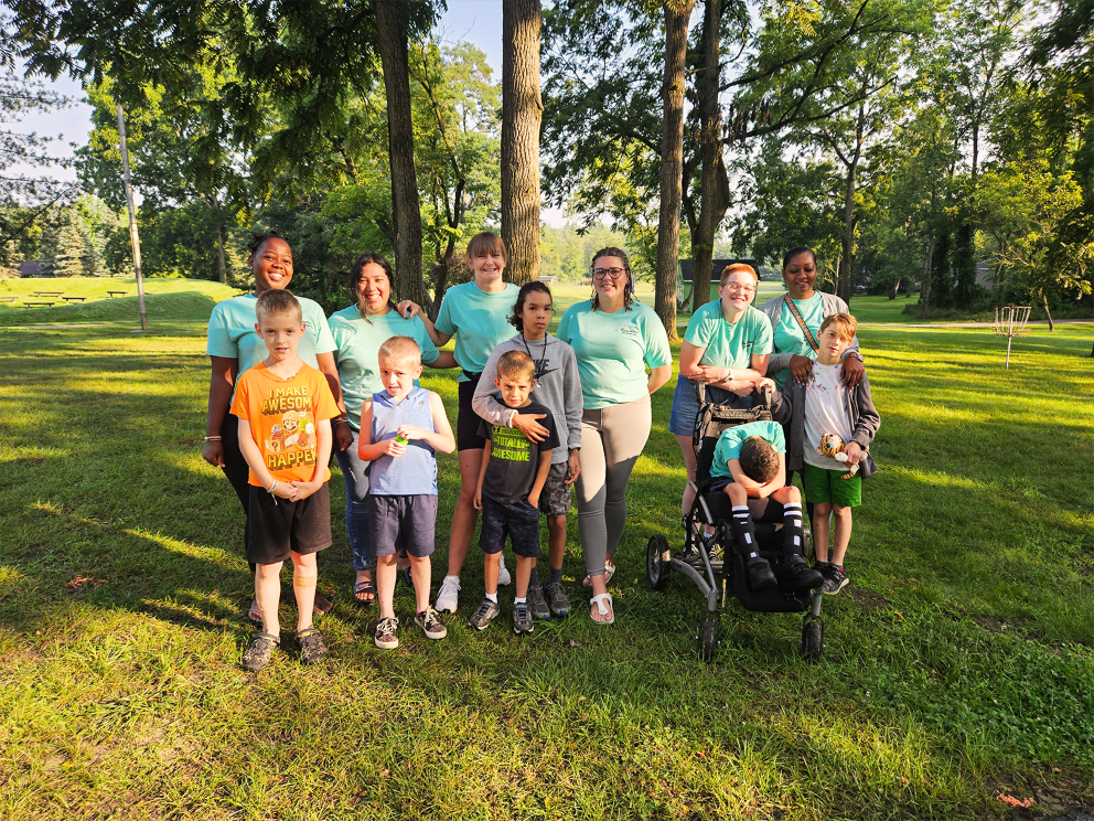 Group of residents and staff in an outdoor setting