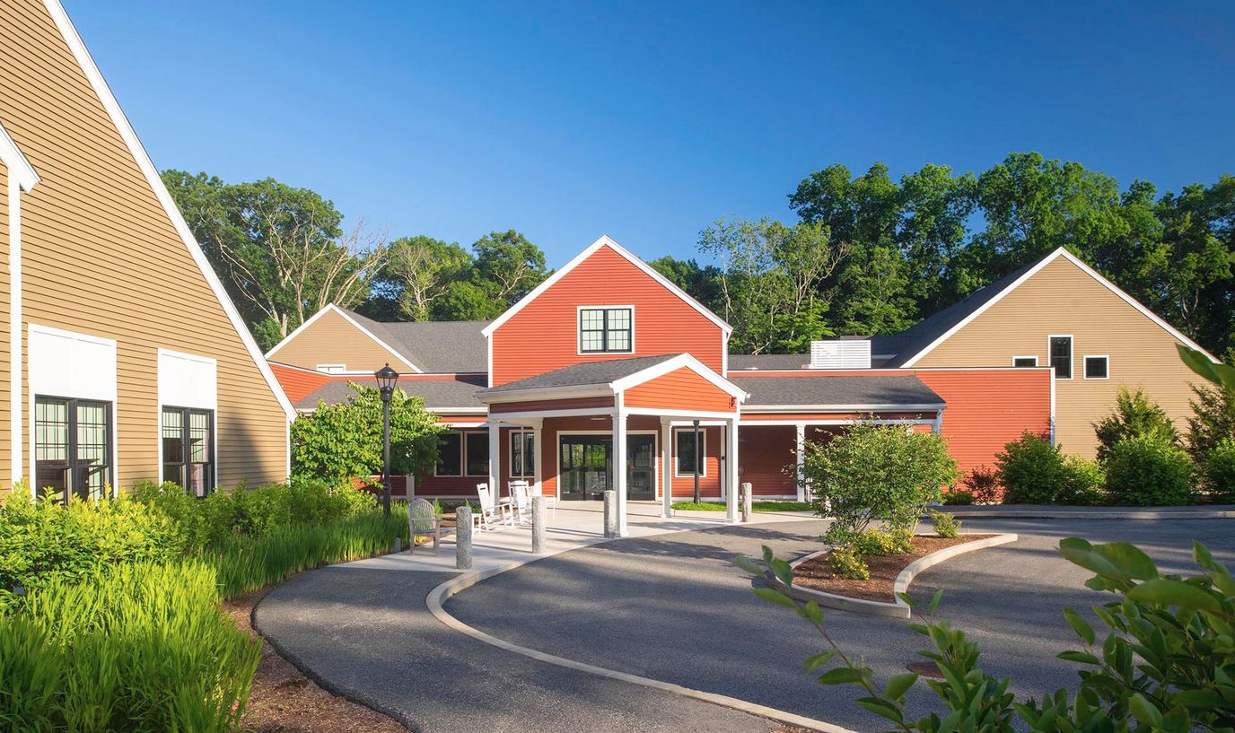 Exterior view of assisted living facility with gardens