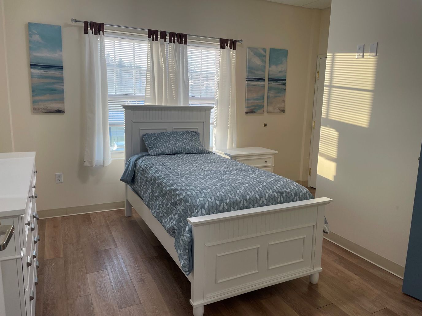 A private resident room with a bed and decor
