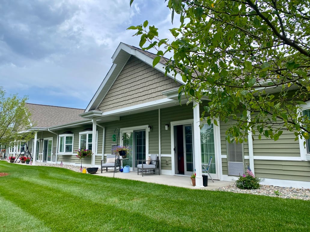 Outdoor view of the assisted living facility with green lawn