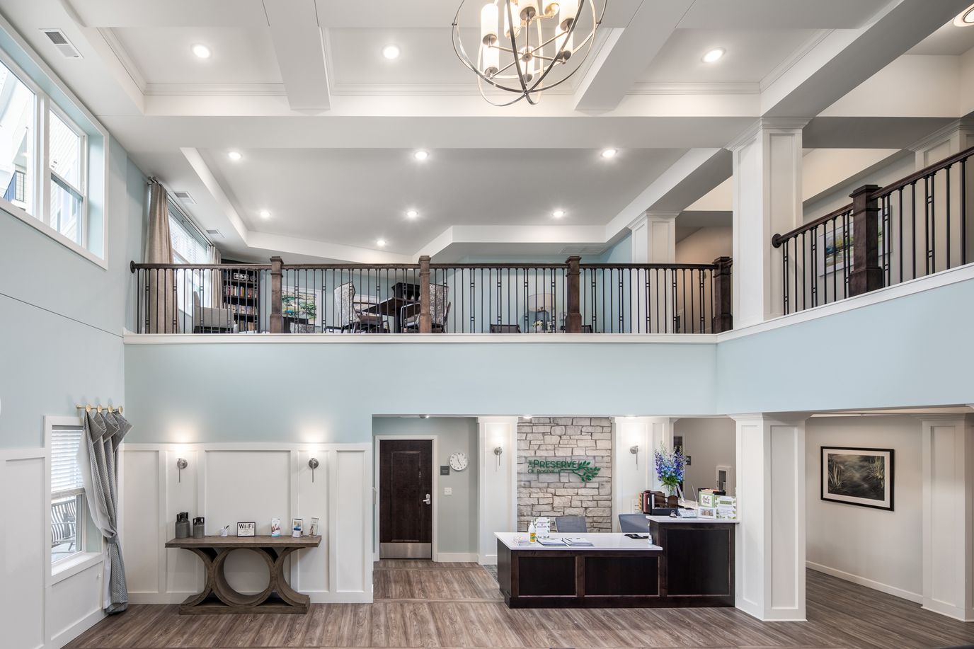 Interior view of a bright common area in a senior living facility.